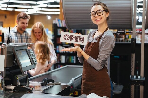 Worker holding an OPEN sign