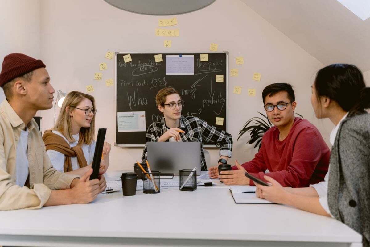 Product team discussing user retention goals at a whiteboard